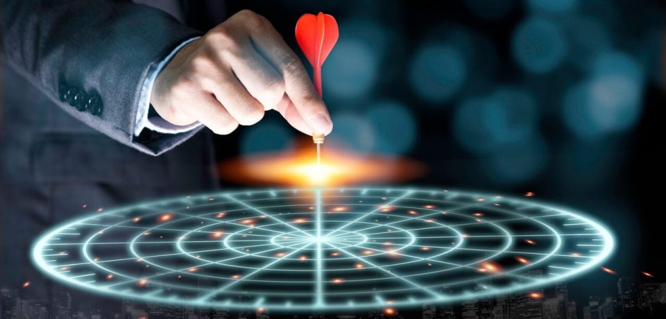 Businessman throwing red arrow dart to virtual target dart board. Setup objectives and target for business investment concept.